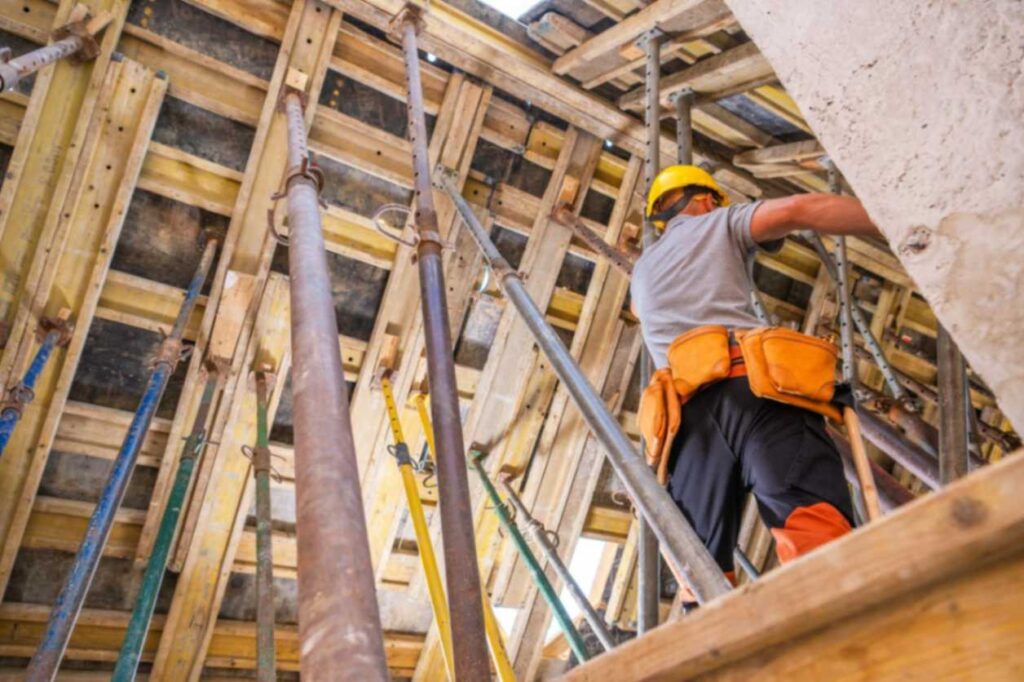 Worker doing structural site inspection: what sets quality custom home builders apart in Billings.