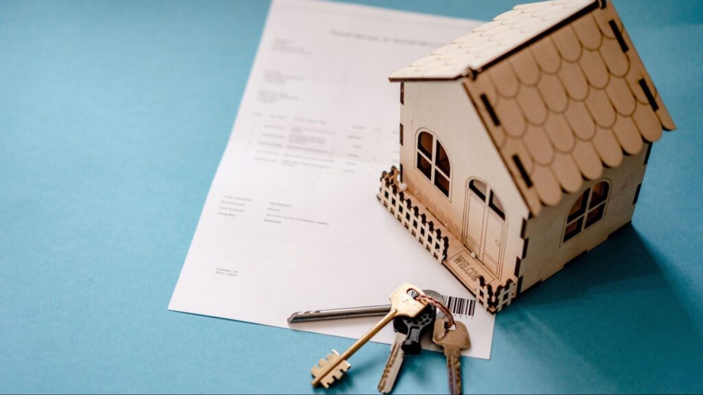 Model house and keys on real estate documents representing the latest trends in the Billings Montana housing market.