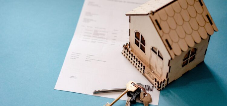 Model house and keys on real estate documents representing the latest trends in the Billings Montana housing market.