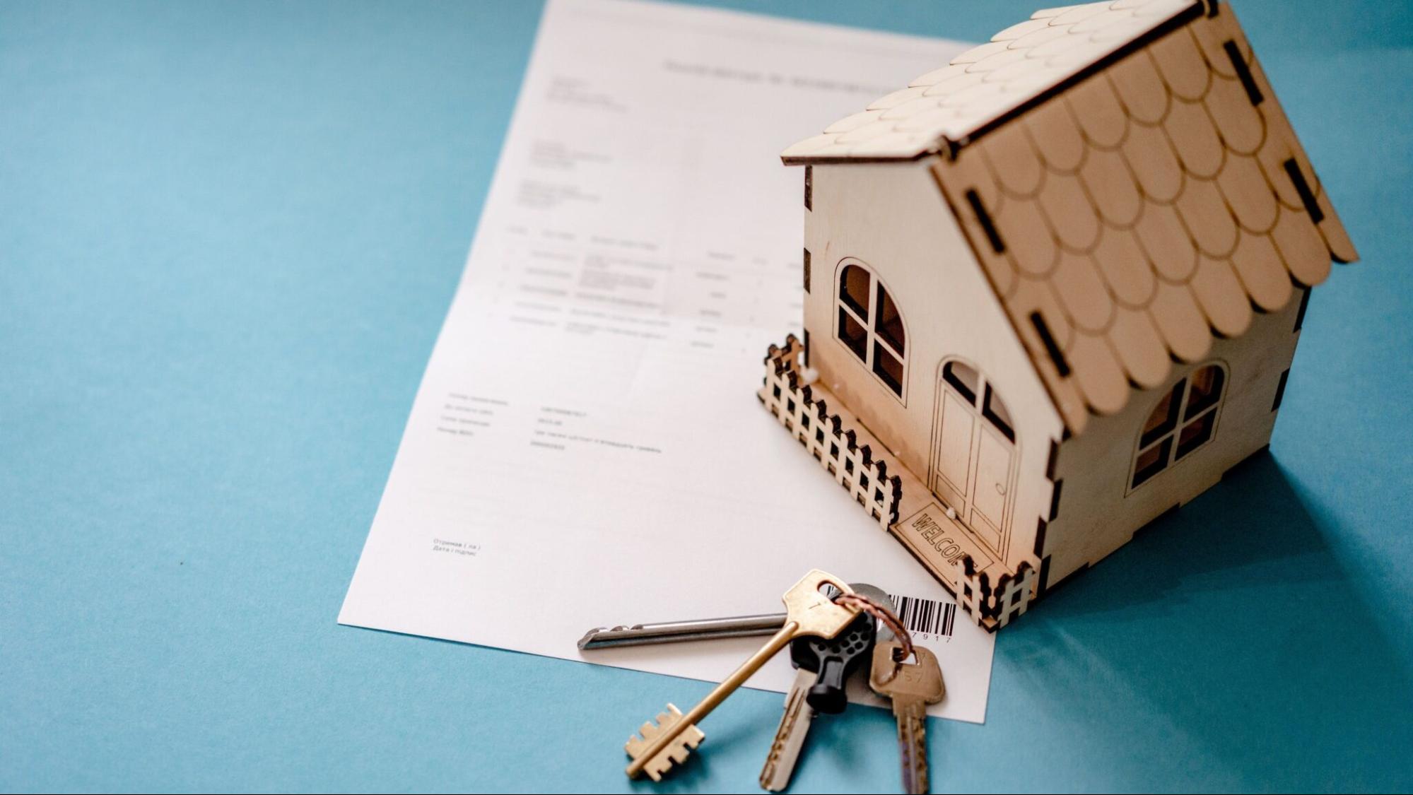 Model house and keys on real estate documents representing the latest trends in the Billings Montana housing market.